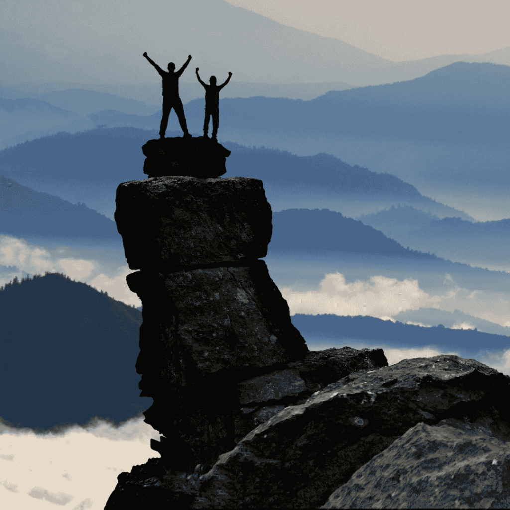 Bel Gamlin Counselling for Self-Worth  in Bradford on Avon . Picture of silhouette of two people on a mountain, arms raised in victory